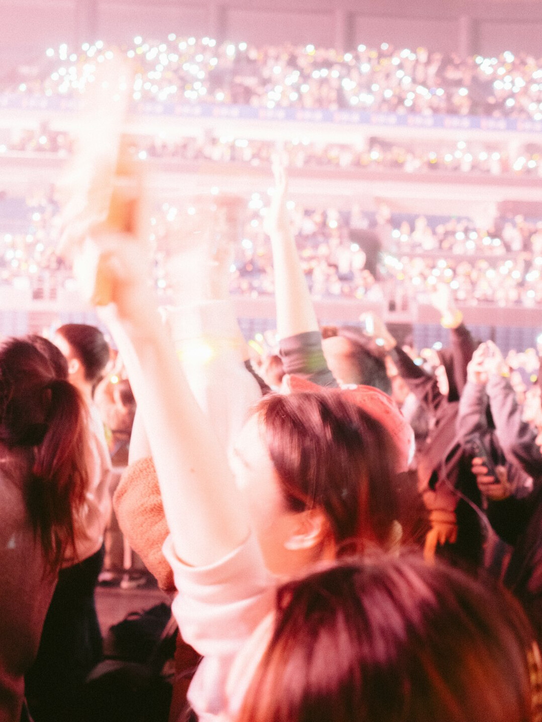Crowd celebrating at a glamorous party with lights