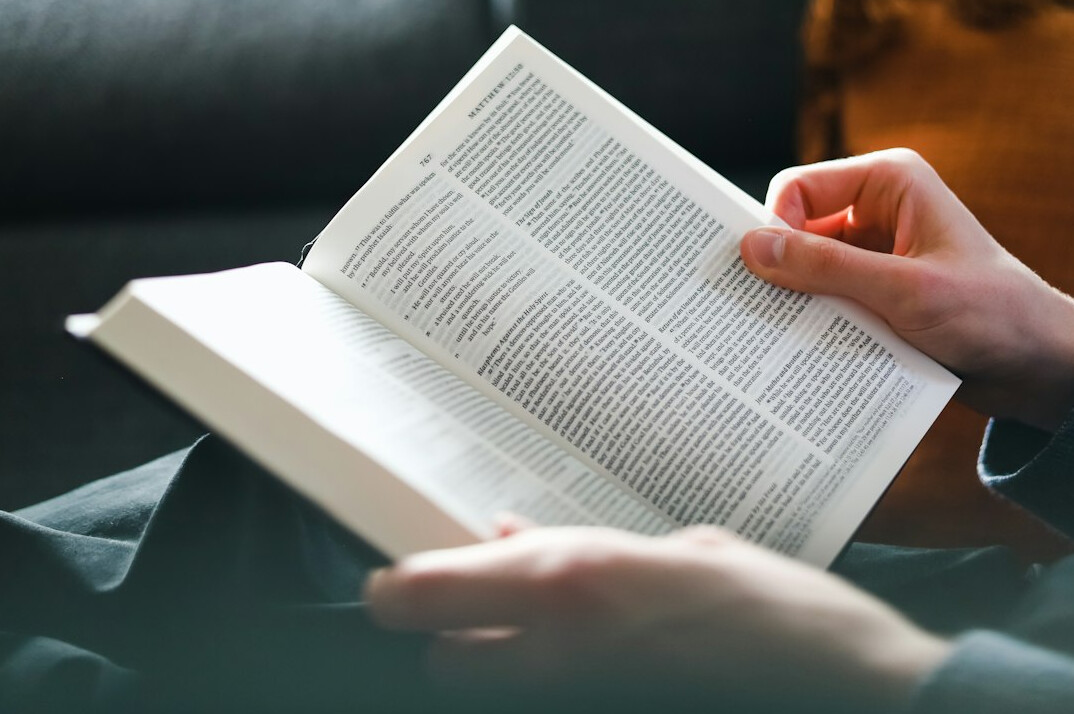 person reading book at home