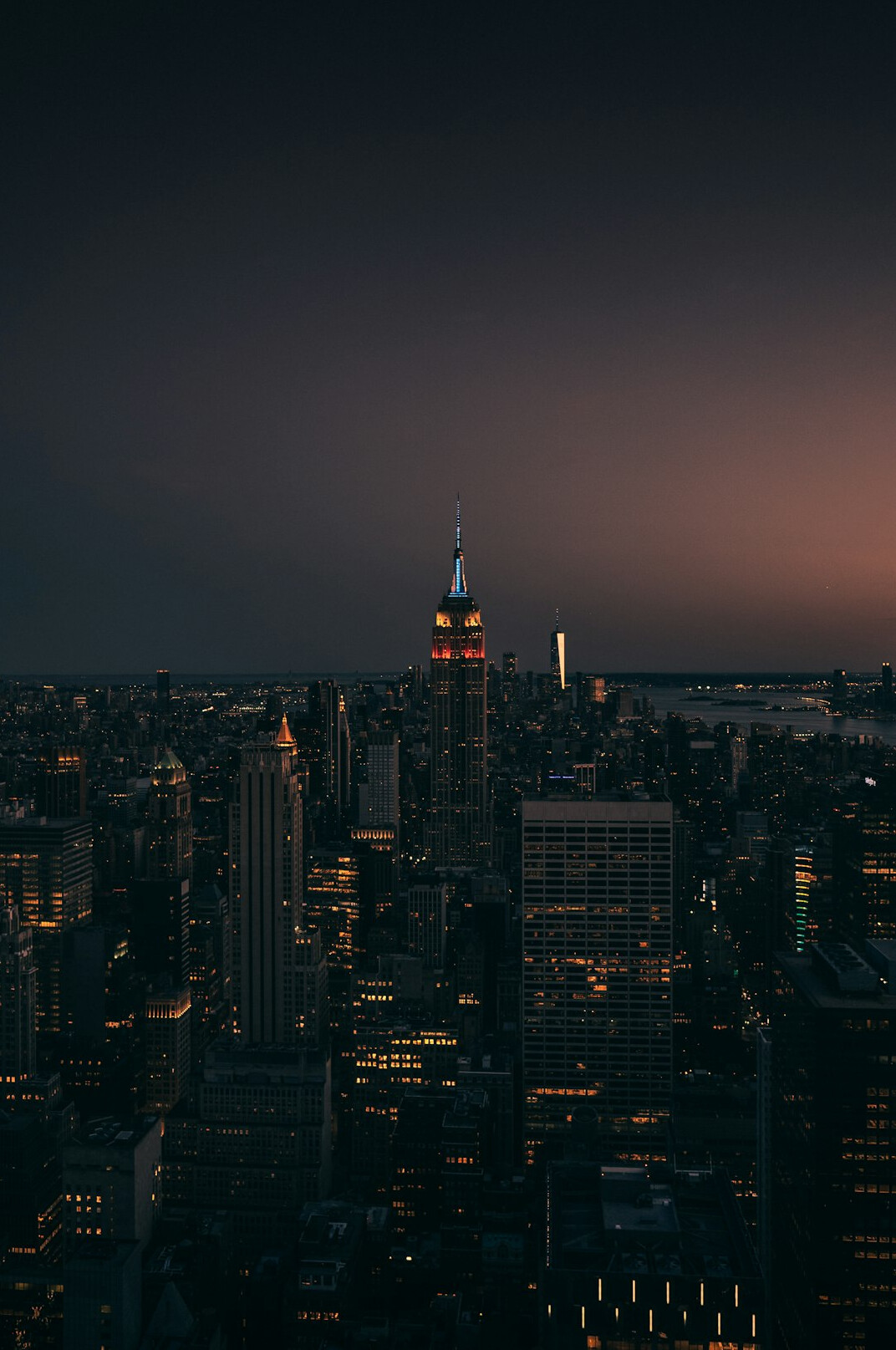 City skyline at dusk with warm lights